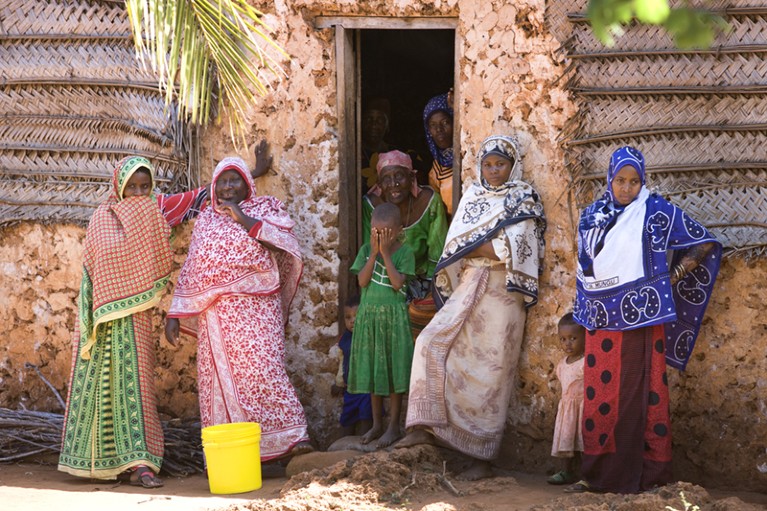 Women outside traditional swahili house, Matemwe, Zanzibar, Tanzania.