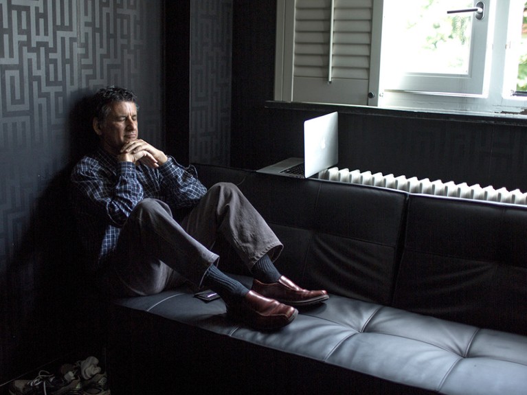 Daniel Levitin sits listening to music while taking a break from work.