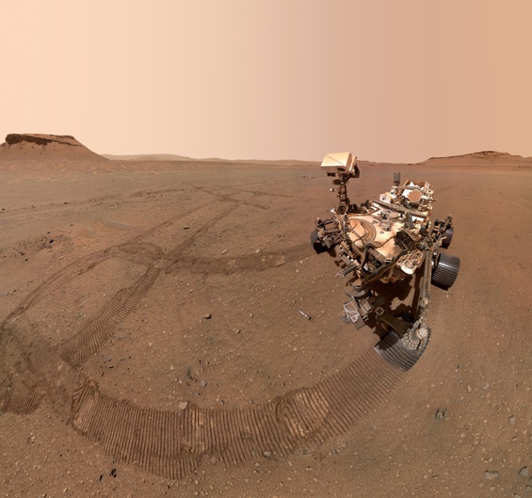 A wide angle view of NASA's Perseverance rover on the surface of Mars with tyre tracks visible