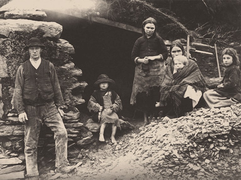 A family at the ruins of their house in Killarney, Ireland, in 1888.