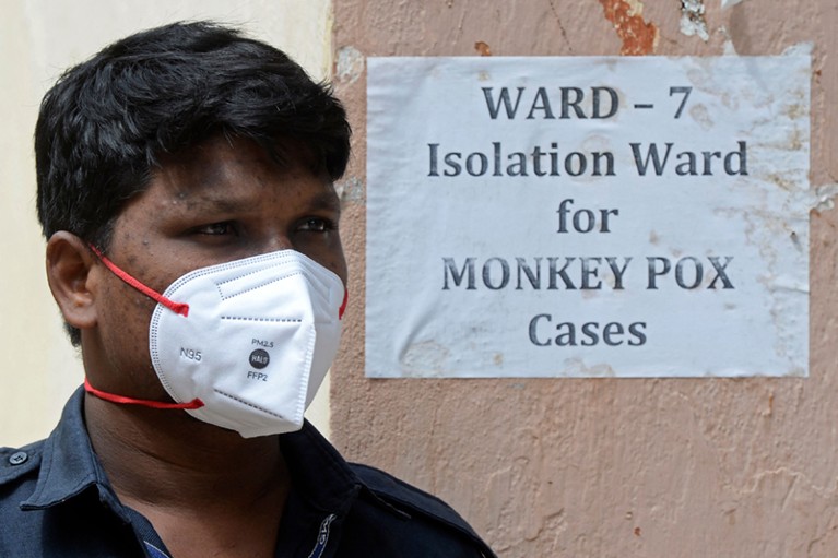 A man stands at the entrance of an isolation ward for monkeypox patients at a Hyderabad hospital on 25 July 2022.