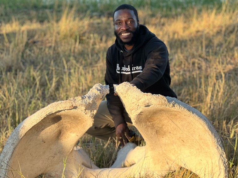 Vashan Wright posing near some elephant bones in the Okavango Delta at one of the camp sites.