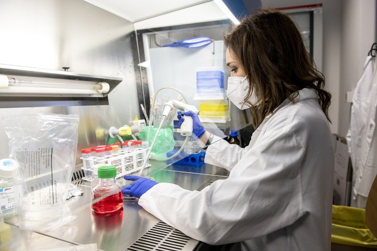 A researcher at Sibylla pipettes liquid in a laboratory