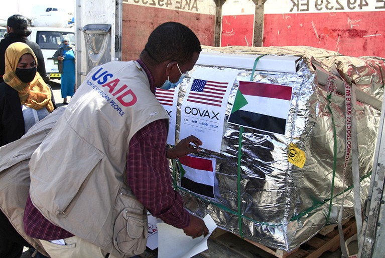 Aid workers check a shipment of coronavirus vaccines sent via airplane by a vaccine-sharing initiative to Khartoum, Sudan, 2022.