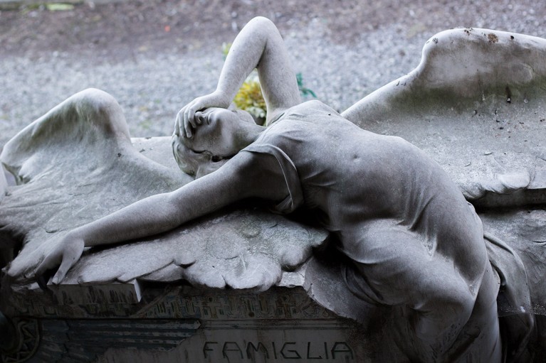 The white marble Ribaudo family tomb featuring a grieving angel sprawled on it's back with hand on head
