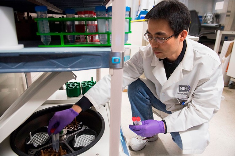 Dr. Benjamin Jin, a biologist working on immunotherapy for HPV+ cancers, works in a lab at the National Institutes of Health.