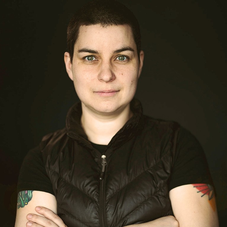 Dr Max Liboiron with arms folded against a dark background