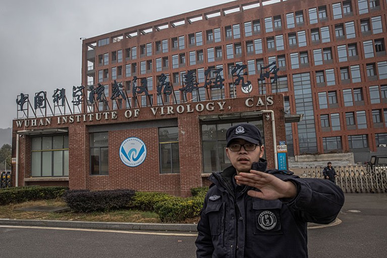 A security staff tries to stop the photographer from taking pictures of Wuhan Institute of Virology in Wuhan, China.