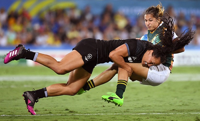 New Zealand's Portia Woodman tackles South Africa's Chane Stadler in a women's rugby sevens match.