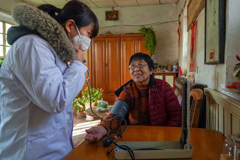 Doctor measures blood pressure for a resident in Dagushan Village of Changqing District in Jinan, east China's Shandong Province