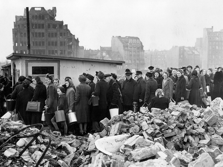 Citizens of Hamburg queuing among the ruins for their soup rations, after world war II.
