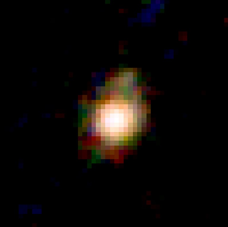 Image of the red, green, and blue galaxy (F444W-F410M-F277W), with the central core and disk prominent.