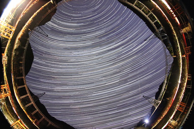A long exposure photograph of the night sky taken from witin the Five-hundred-meter Aperture Spherical Telescope.