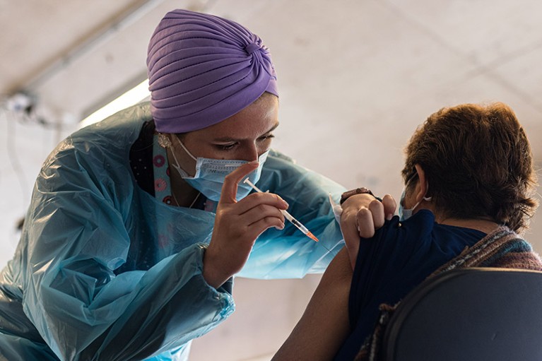 A healthcare worker inoculates a person with the fourth booster dose against Covid-19 in Viña del Mar, Chile.