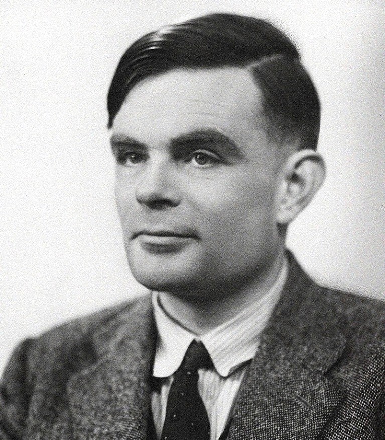 Black and white portrait photo of Alan Turing from 1951