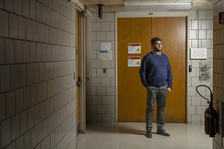 Ranga Dias, a professor of mechanical engineering and physics, University of Rochester, is standing in the school hallway, 2023.