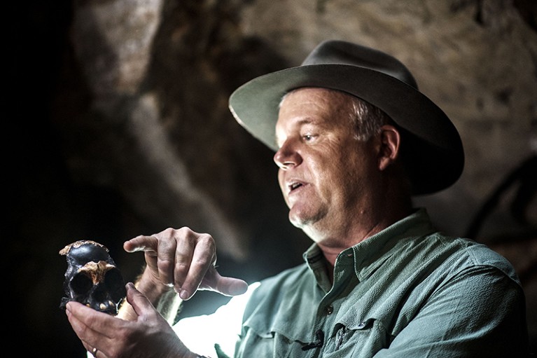 Professor Lee Berger shows a full-scale reproduction skull of a hominid named Leti, found inside the Rising Star Cave System.