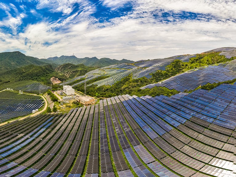 Aerial view of rows of solar panels on a hillside in Zhumadian, Henan Province of China.