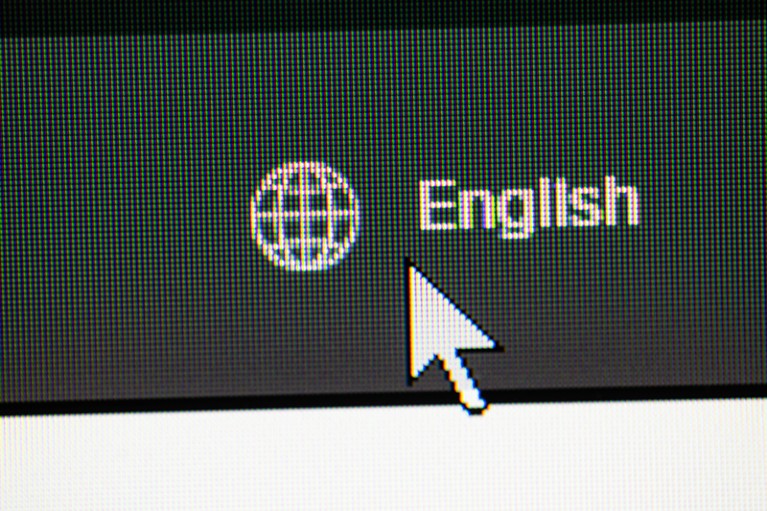 A cursor clicking on ENGLISH language web button on a website.
