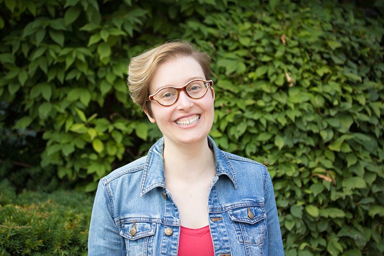 A portrait of Jennifer Polk in front of green trees.