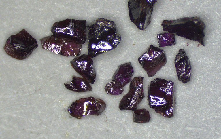 Shards of a purple crystal on a table.