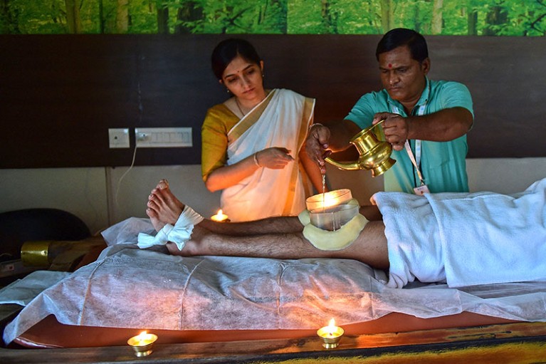 An ayurvedic doctor performs a traditional therapy for treatment of knee pain, at a hospital on the outskirts of Ahmedabad.
