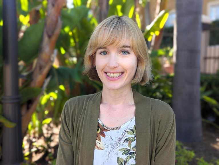 A headshot of a smiling Caitlin Aamodt taken outside