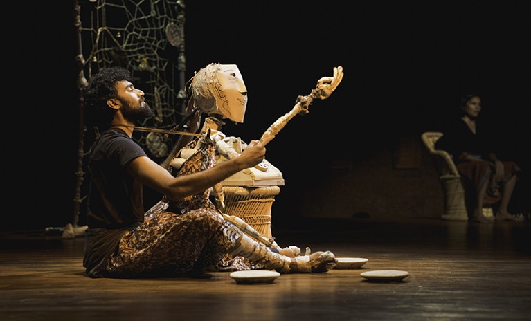 Vijay Ravikumar performing puppetry, in the Lentils and Stones Adishakti Show, with a wooden puppet.