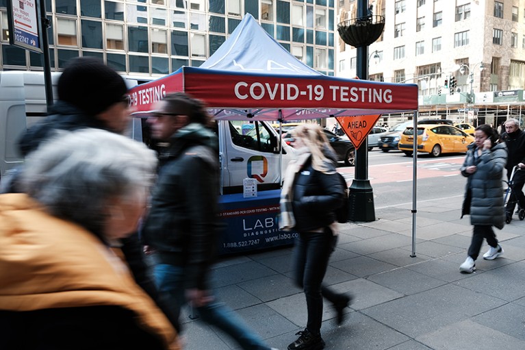 A Covid-19 testing tent sits along a busy Manhattan street in New York City.