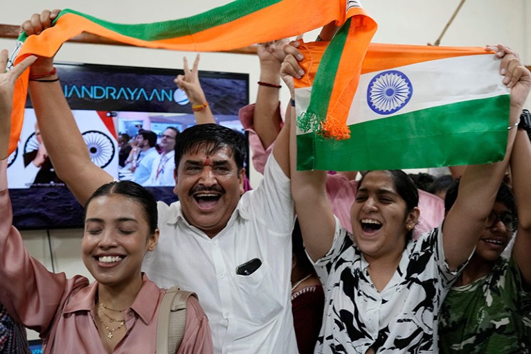 People celebrate the successful landing of Chandrayaan-3 at the Nehru Planetarium in New Delhi, India.