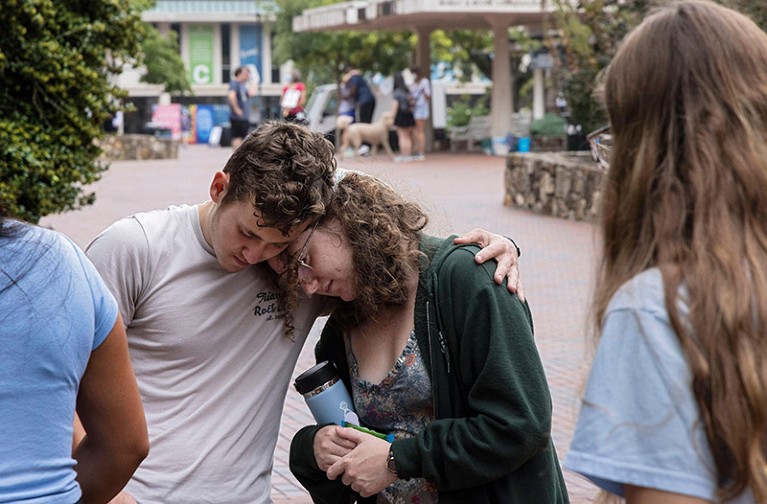First-year students Lucas Moore and Katie Fiore embrace following a shooting on the UNC campus.