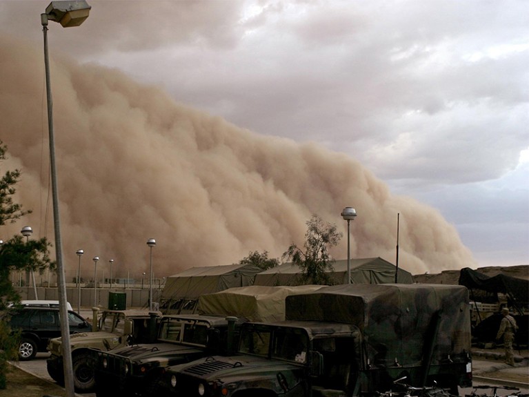 A massive sand storm cloud is close to enveloping a military camp as it rolls over Al Asad, Iraq.