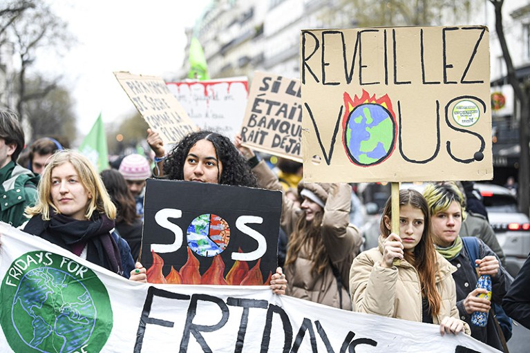 Young people holding placards up at a Fridays For Future Climate Rally in Paris