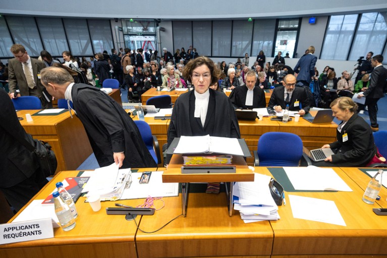 Lawyers of Swiss applicants prepare for the European Court of Human Rights hearing inside the court room