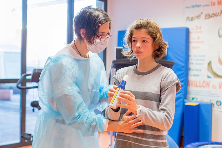 A 13 year old girl suffering from mucoviscidosis breathes into a spirometer during a visit to Limoges hospital, France.