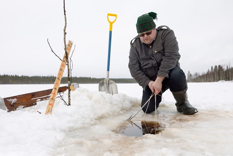 Close-up of Tero Mustonen winter fishing in the ice