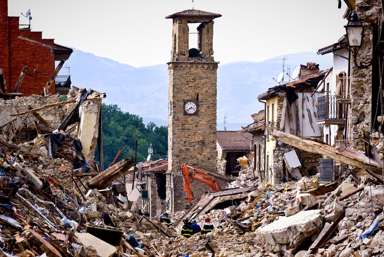 Firefighters continue removing rubble near the bell tower in Amatrice, central Italy on August 30, 2016 Italy.