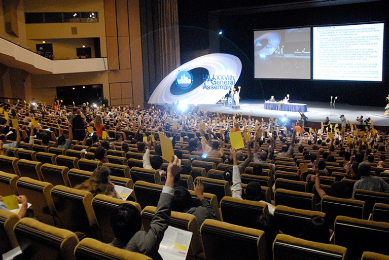 Delegates vote during the IAU 2006 General Assembly.