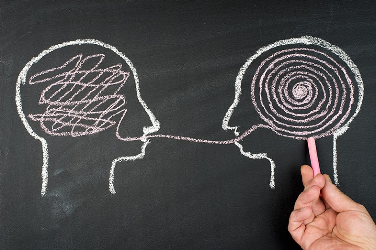 An chalkboard illustration of two figures communicating and understanding each other.