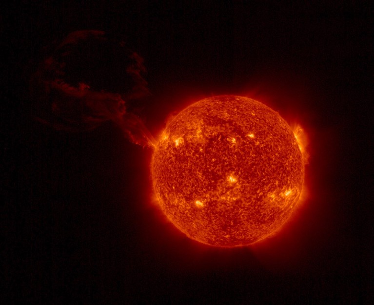 View of the whole sun showing a huge solar flare erupting from the surface a considerable distance above the surface