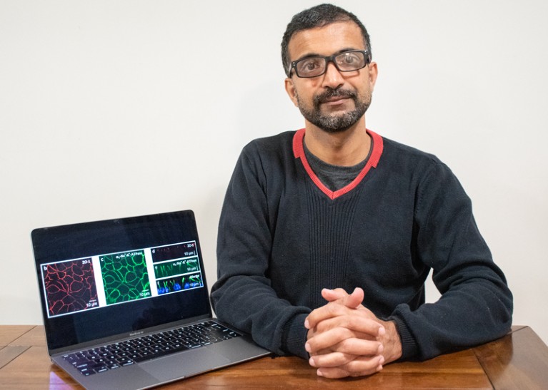 Vinod Suresh sat at a desk with his laptop