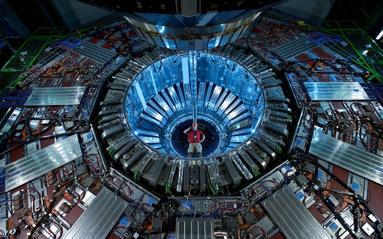 Researcher standing in one end of the CMS (Compact Muon Solenoid) detector at CERN, Geneva.