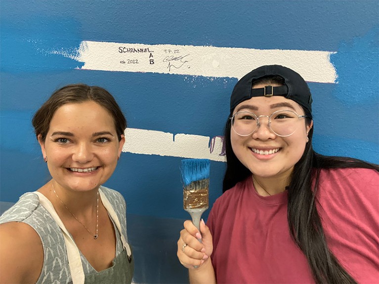 Catherine Schrankel and student Jenna Luc painting the lab blue