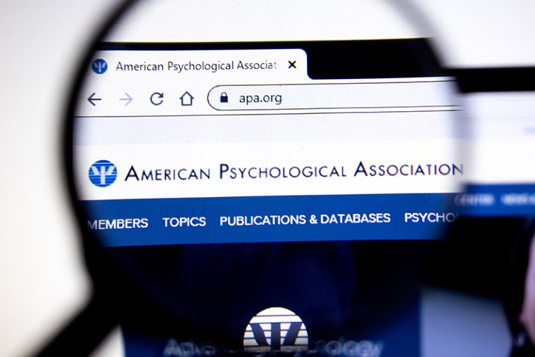 The American Psychological Association website viewed through a magnifying glass.