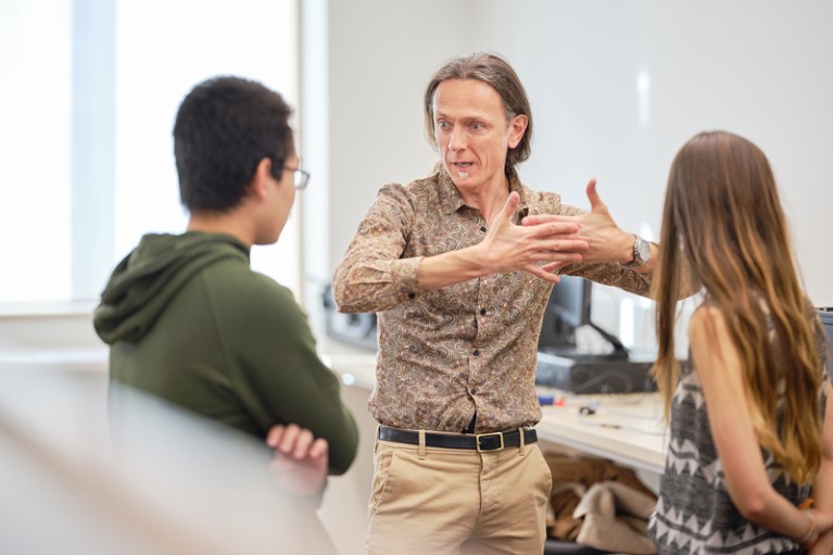 Andrea Morello gestures while talking to students