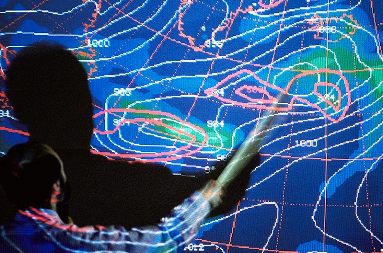 Meteorologist analysing a weather map obtained from surveys of Atlantic storms.