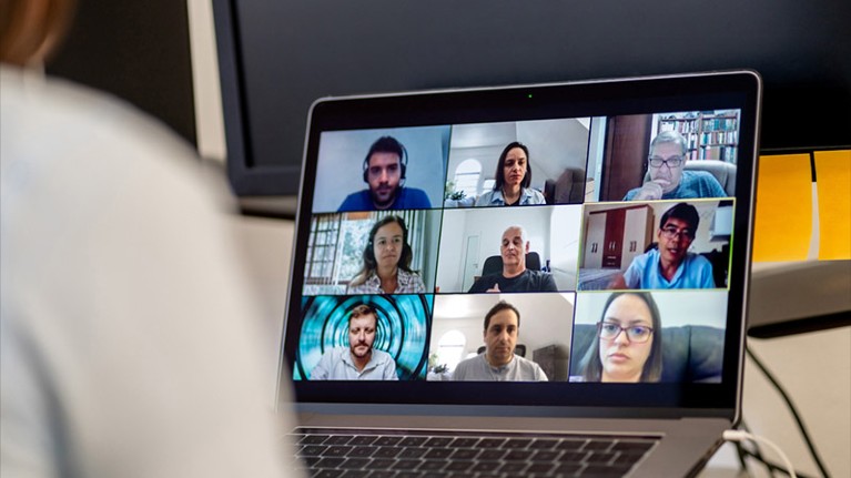 A group of people hold a video call meeting.