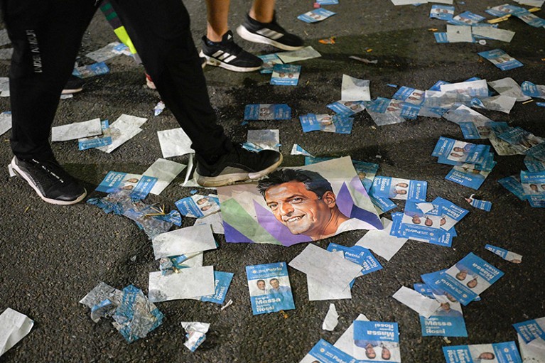 Abandoned flyers and posters for Argentine Economy Minister and presidential candidate for the Union por la Patria party, Sergio Massa litter the ground following the election result being announced.