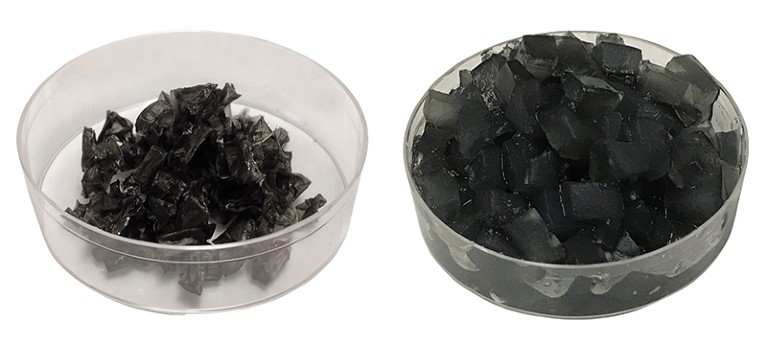 Two transparent dishes, side by side. The left dish contains dry particles of a black substance. The right contains black cubes of a substance with a jelly-like consistency.
