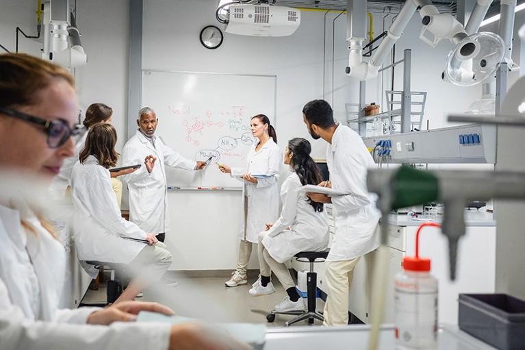 A group of scientists having a meeting in a laboratory.